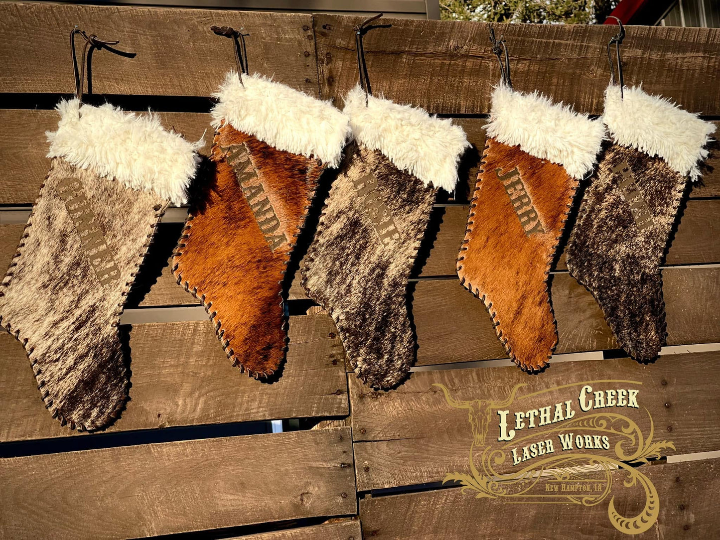 Brown leather and cowhide Christmas stockings with fur tops and rustic western styling