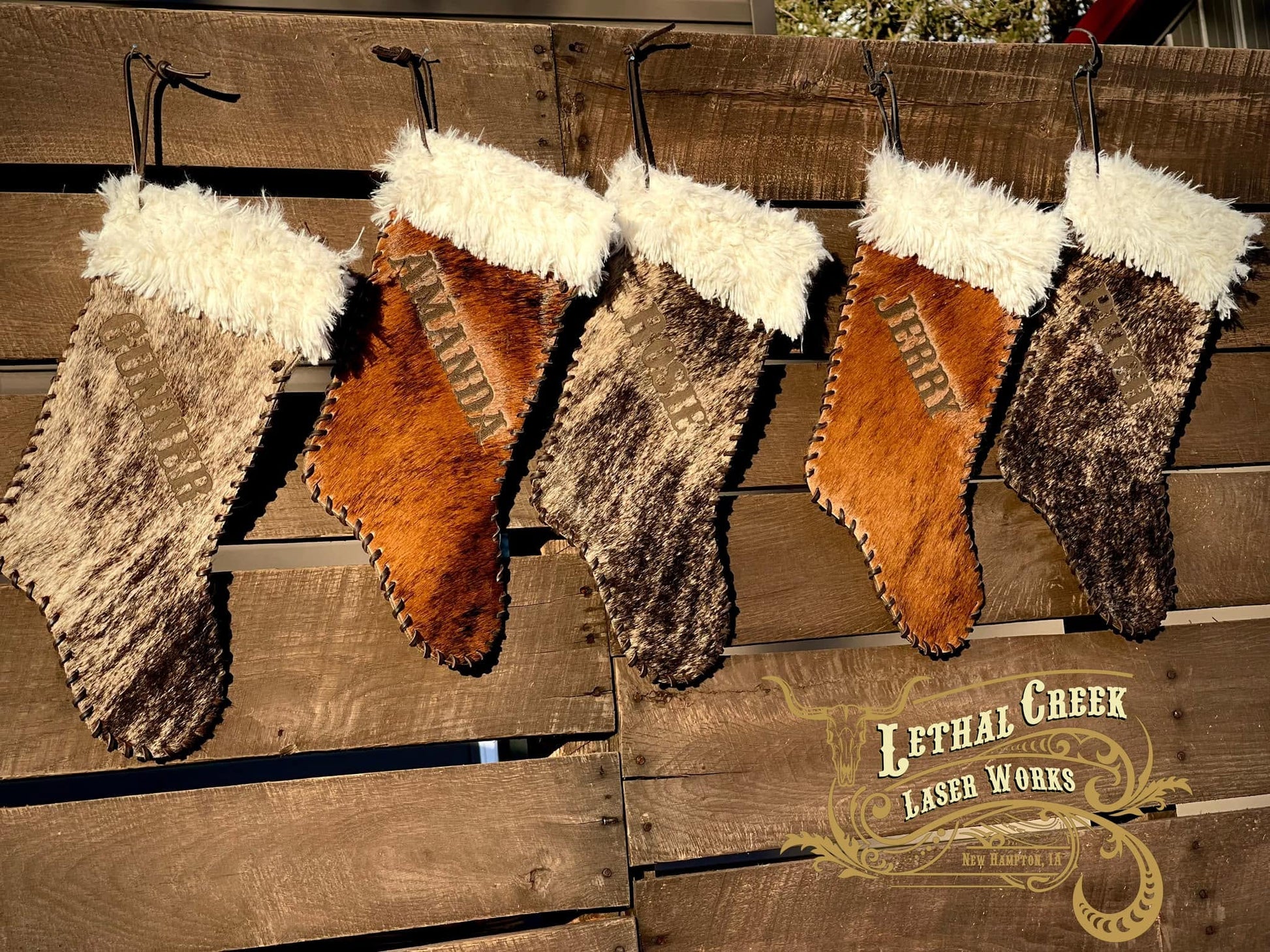 Brown leather and cowhide Christmas stockings with fur tops and rustic western styling