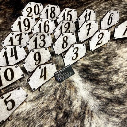 Rustic cowhide wedding table numbers custom laser engraved for western events