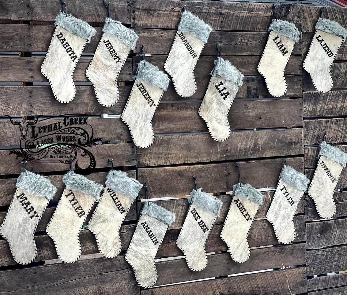 Collection of custom 16-inch cowhide Christmas stockings with leather stitching, fur tops and personalized designs