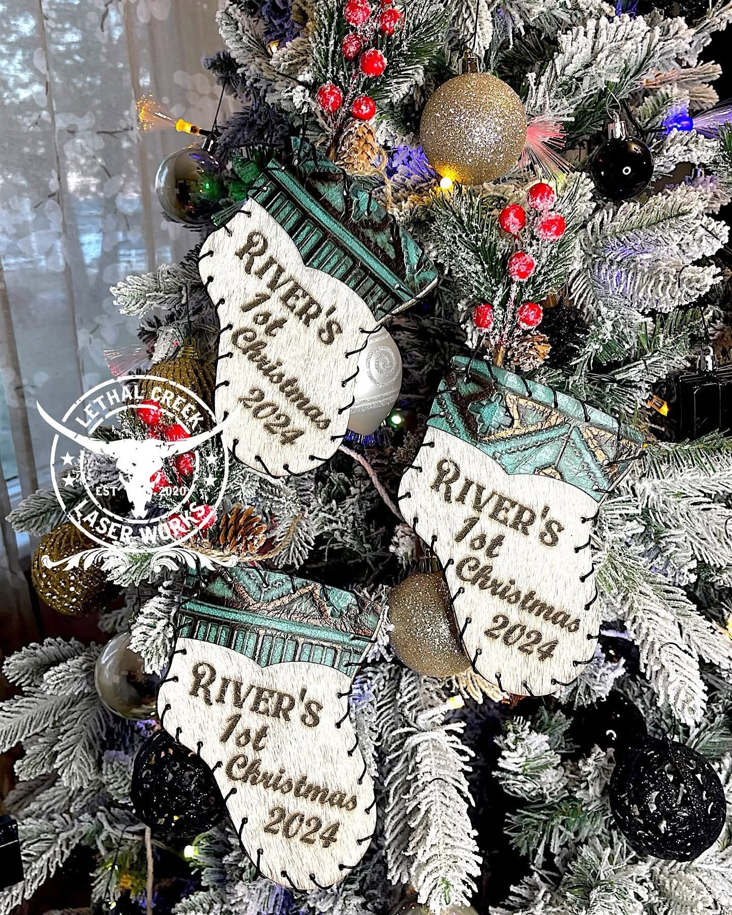 Personalized western cowhide mini stocking ornaments displayed on a Christmas tree